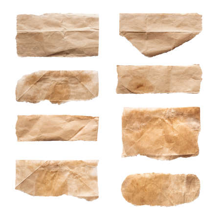 Close up of a ripped piece set of brown paper on white backgroundの写真素材
