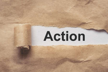 Business and finance. Torn brown paper on a red background, the text - ACTIONの写真素材