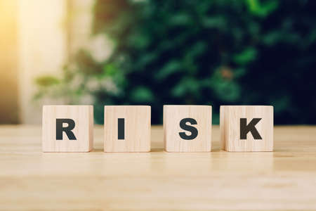 Word RISK block wood on wooden table background. RISK Business concept.の写真素材