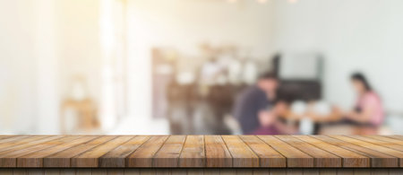 Empty wood table and blurred light table in coffee shop and cafe with bokeh background. product display template.の写真素材
