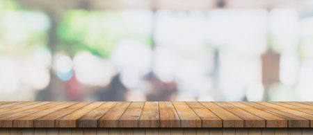 Empty wood table and blurred light table in coffee shop and cafe with bokeh background. product display template.の写真素材