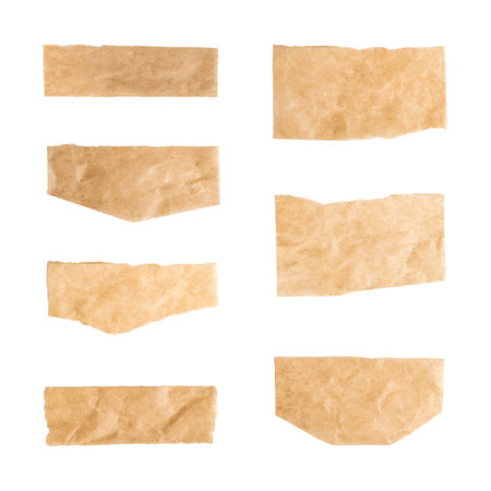 Close up of a ripped piece set of brown paper on white backgroundの写真素材