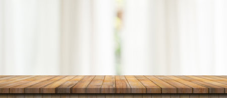 Empty wood table top on blur white window background. For product or foods montage.の写真素材