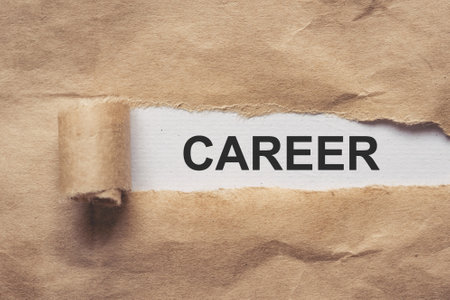 Torn brown paper on white background the text careerの写真素材