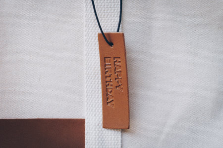 Close up Leather tag on bag with text Happy birthdayの写真素材