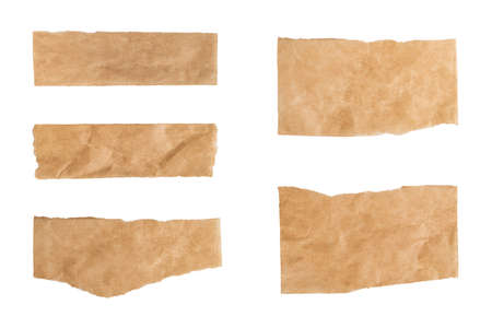 Close up of a ripped piece set of brown paper on white backgroundの写真素材