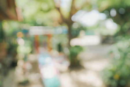 defocused bokeh and blur background of garden trees in sunlight.の写真素材
