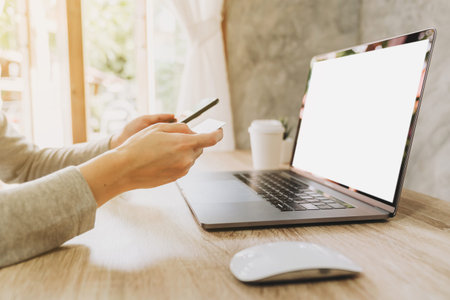 woman using smart phone and credit card for shopping online in coffee shop