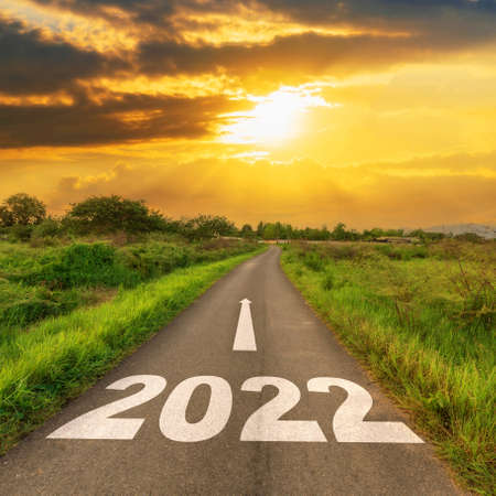 Empty asphalt road and New year 2022 concept. Driving on an empty road to Goals 2022 with sunset.の写真素材