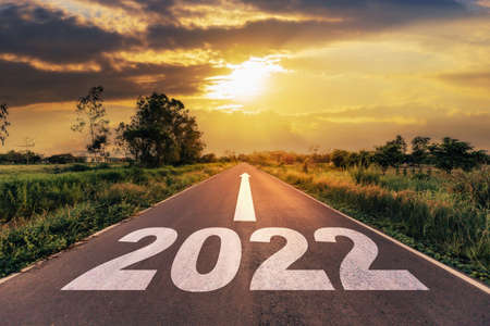 Empty asphalt road and New year 2022 concept. Driving on an empty road to Goals 2022 with sunset.の写真素材