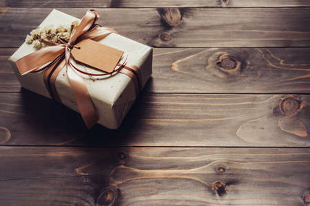 Craft gift box on table wooden background with copy spaceの写真素材