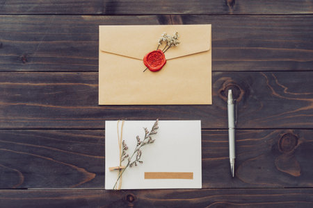 Above of greeting card and pen on wood background