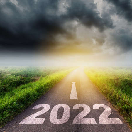 New Year 2022 Goals Concept : Empty asphalt road clouds  and sunset with text go to New year 2022の写真素材