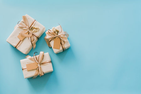 Craft paper gift boxs set on blue background with copy space for text.