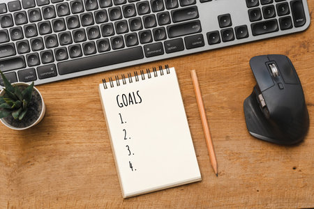 Business concept New year Goals, keyboard on wood table with noteの写真素材