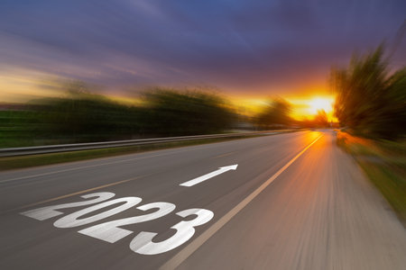 Motion blur empty asphalt road and New year 2023 concept. Driving on an empty road to Goals 2023 with sunset.の写真素材