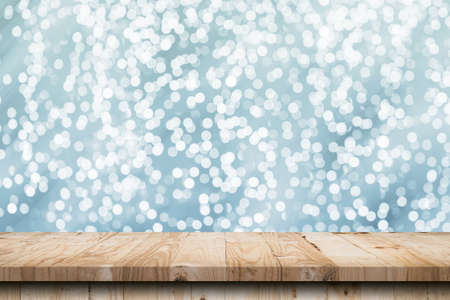 Abstract circular boken nigth and wood table for christmas background with spaceの写真素材