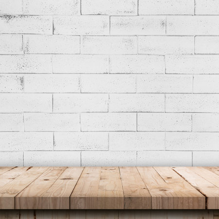 Empty wooden table top and white brick wall and rough crack background textureの写真素材
