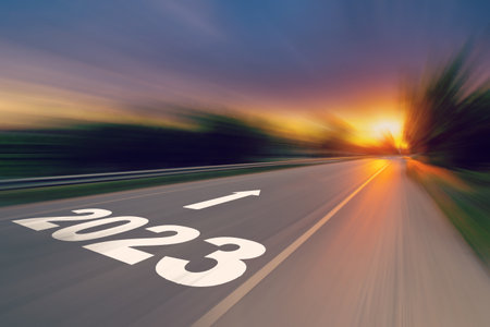 Motion blur empty asphalt road and New year 2023 concept. Driving on an empty road to Goals 2023 with sunset.の写真素材