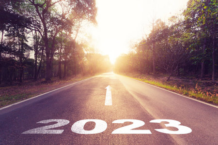 Empty asphalt road and New year 2023 concept. Driving on an empty road to Goals 2023 with sunset.の写真素材
