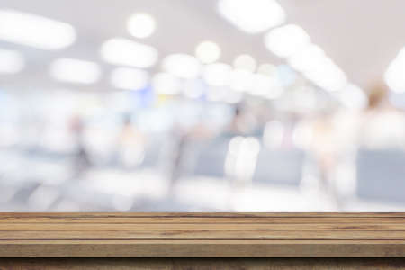 Empty wooden table anb Abstract blur airport interior for backgounrdの写真素材