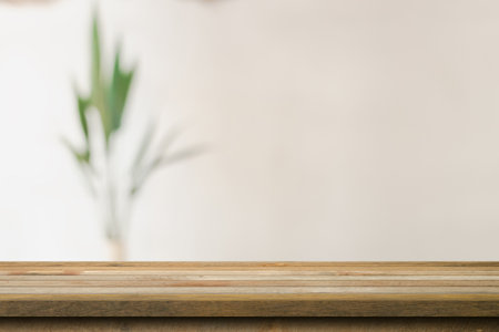 Wooden table top with blurred in coffee shop and cafe background for display montage, copy space.の写真素材