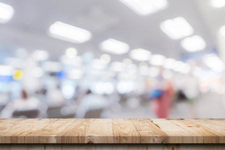 Empty wooden table anb Abstract blur airport interior for backgounrdの写真素材