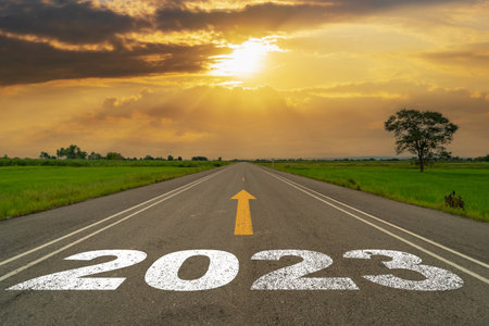 Empty asphalt road and New year 2023 concept. Driving on an empty road to Goals 2023 with sunset.の写真素材