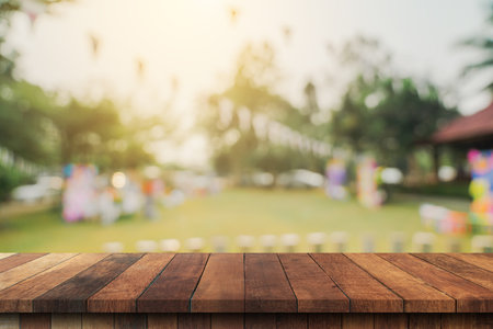 Empty wooden table top and Abstract blurred light bokeh and blur background of garden trees in sunlight. product display template with copy space.の写真素材