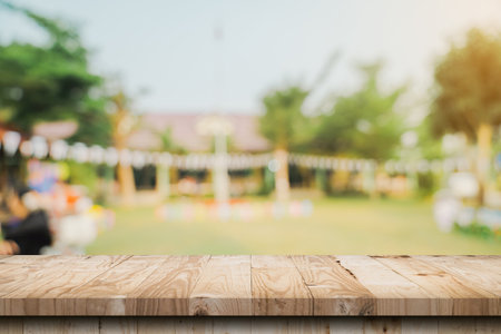 Empty wooden table top and Abstract blurred light bokeh and blur background of garden trees in sunlight. product display template with copy space.の写真素材