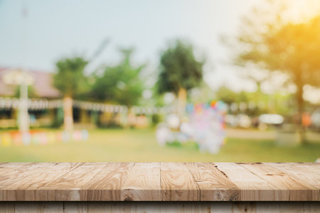 Empty wooden table top and Abstract blurred light bokeh and blur background of garden trees in sunlight. product display template with copy space.の写真素材