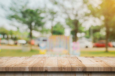 Empty wooden table top and Abstract blurred light bokeh and blur background of garden trees in sunlight. product display template with copy space.の写真素材