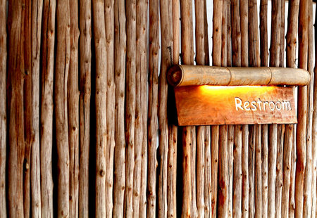 Restroom direction plate made from bamboo make you feel clam and fresh with natureの写真素材