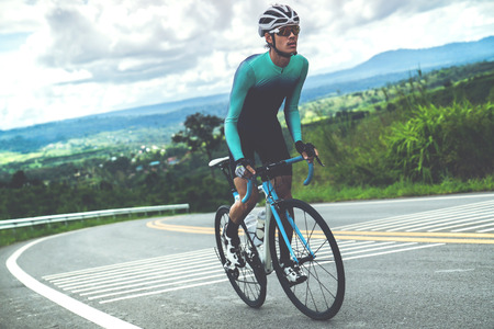 Cyclists are cycling, climbing up to the top.の写真素材