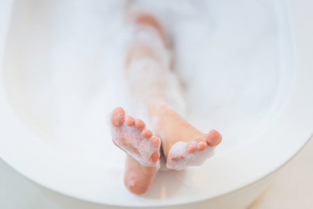 Women's feet she was bathing in a a bathtub with happinessの写真素材