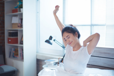 Asian woman woke up from bedの写真素材
