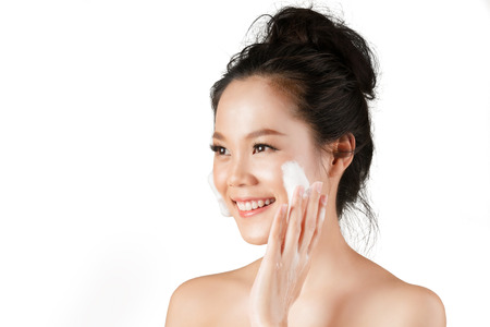 Asian woman use  facial foam to wash cosmetics off the face.の写真素材