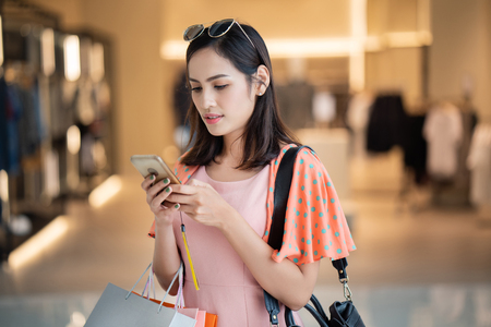 asian woman  using cell phones.の写真素材