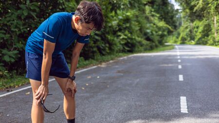 Asian men are tired from running.の写真素材