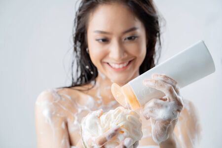 Asian woman being happy with the shower. Studio conceptの写真素材
