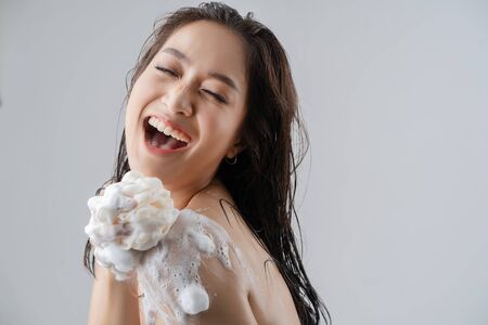 Asian woman being happy with the shower. Studio conceptの写真素材