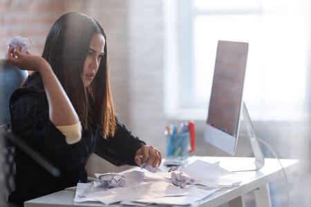 Asian businesswomen are failing from work. She crumpled the paper.の写真素材
