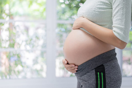 Pregnant happy woman touching belly