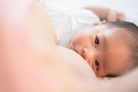 Newborn baby sucking breast milk