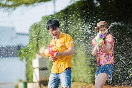 Asian people are using water guns play songkran festival in the summer april