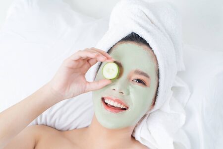 Asian woman doing facial maskの写真素材