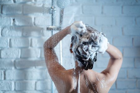 The back of a woman shower she is washing my hairの写真素材