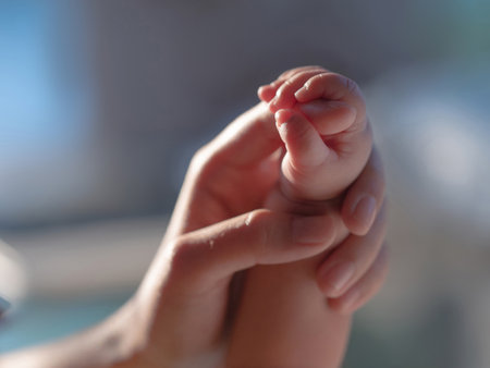 Newborn baby is holding the mother's handの写真素材