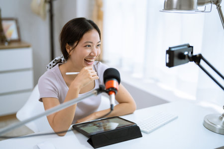 Asian woman Teaching online at home to studentsの写真素材