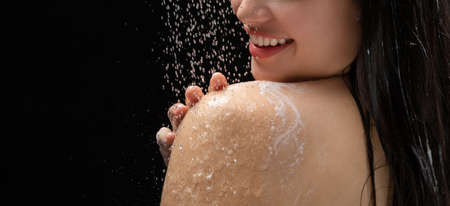 Asian woman She takes a shower and washes her hair. in the black backgroundの写真素材